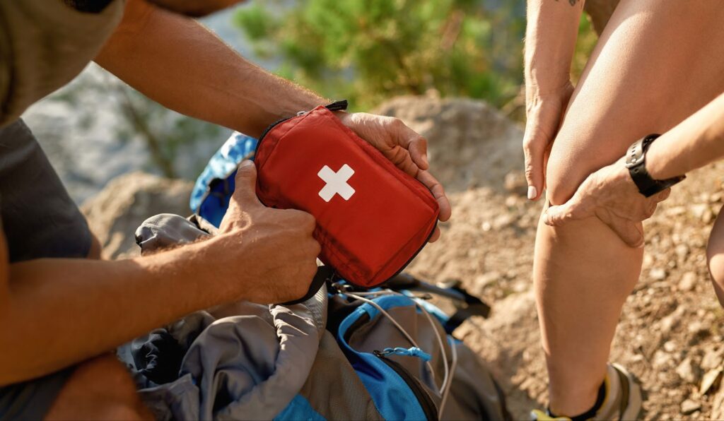 Applying an emergency kit to a leg. Importance of having a first aid kit at home